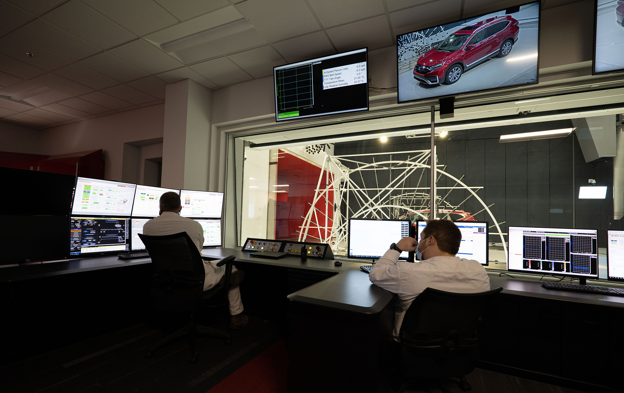 HALO Wind Tunnel control room — three engineers monitoring aeroacoustic test data in real-time